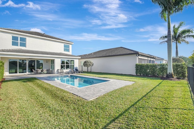 view of swimming pool featuring a yard and a patio area