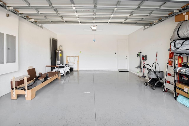 garage with a garage door opener, electric panel, and water heater