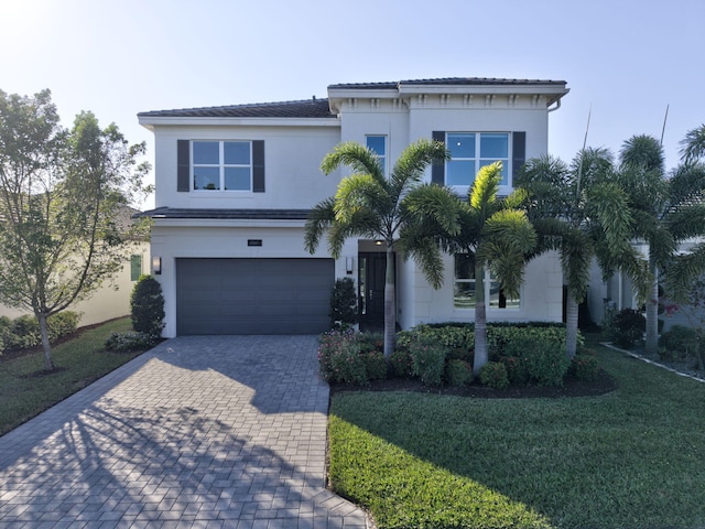 view of front of house featuring a garage and a front yard