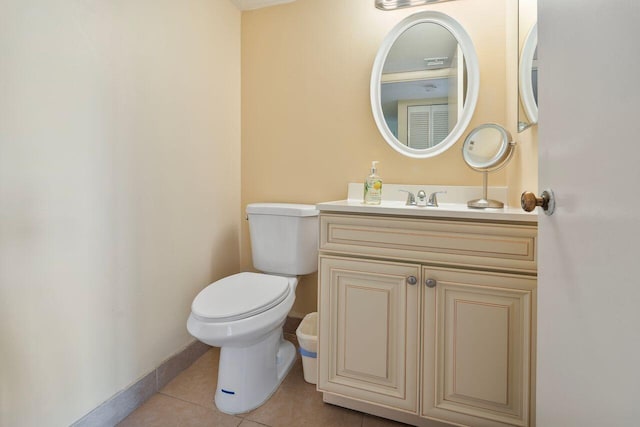 bathroom with vanity, toilet, and tile patterned flooring