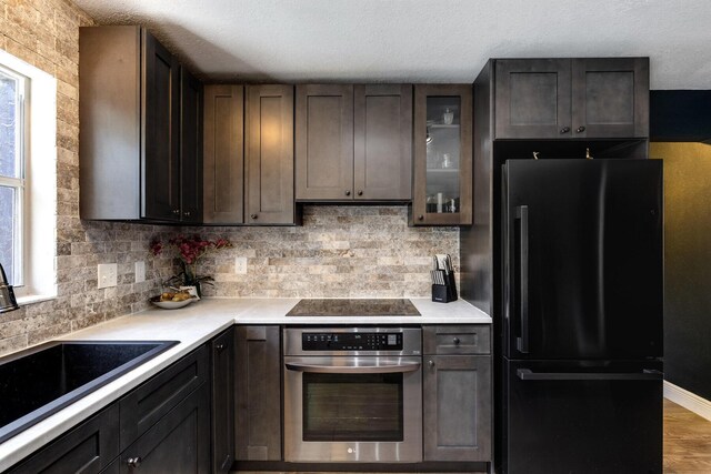 kitchen featuring dishwasher, sink, a kitchen island, and light wood-type flooring