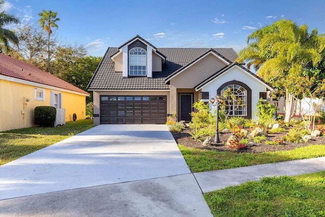 view of front of house featuring a garage and a front lawn