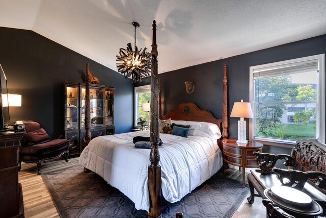 bedroom featuring vaulted ceiling and light hardwood / wood-style floors