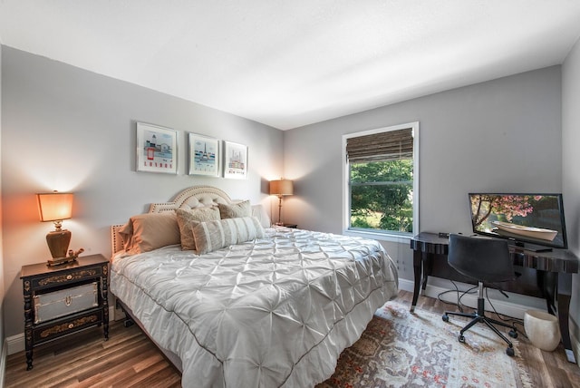 bedroom with hardwood / wood-style flooring