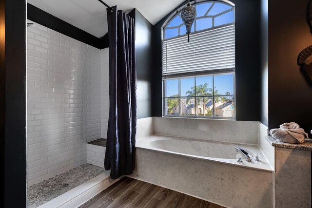 bathroom featuring hardwood / wood-style flooring, vanity, independent shower and bath, and vaulted ceiling