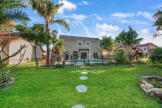 view of yard with a fenced in pool and a pergola