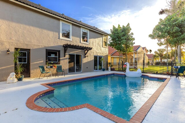 view of swimming pool featuring a pergola and a patio area