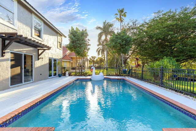 view of pool with a pergola and a patio area