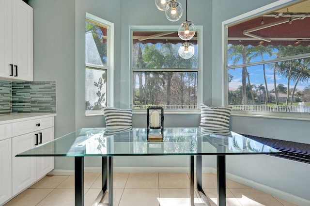 dining space featuring a wealth of natural light and light tile patterned floors