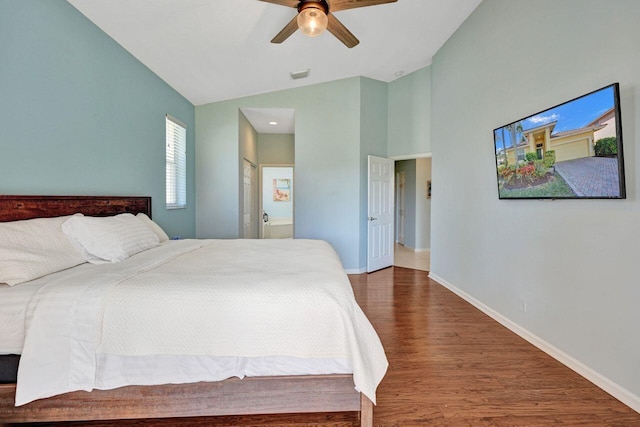 bedroom with ceiling fan, high vaulted ceiling, dark hardwood / wood-style flooring, and ensuite bath