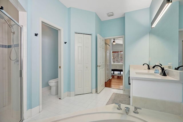 bathroom featuring toilet, vanity, tile patterned floors, and walk in shower