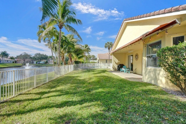 view of yard featuring a patio area and a water view