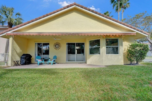 rear view of property with a patio and a lawn