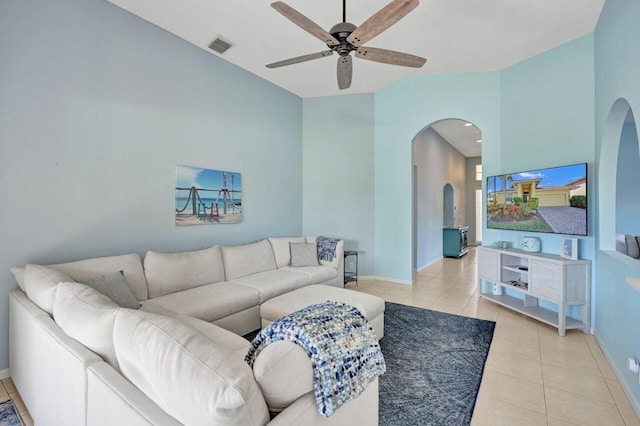 living room featuring lofted ceiling, light tile patterned floors, and ceiling fan