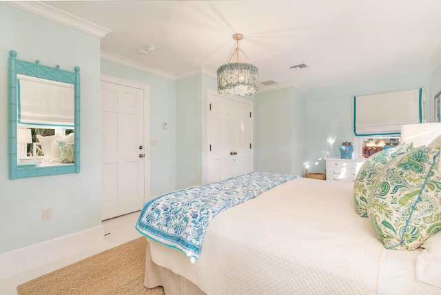 carpeted bedroom featuring crown molding and an inviting chandelier