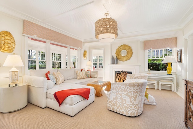 living room with ornamental molding and carpet