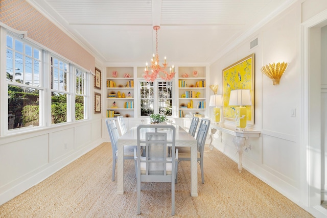 carpeted dining area featuring crown molding, built in features, and a notable chandelier