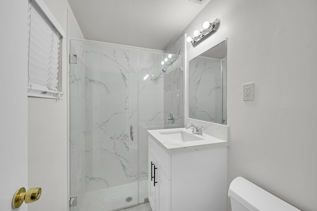 bathroom featuring an enclosed shower, vanity, and toilet