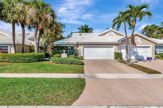 view of front of home with a garage and a front yard