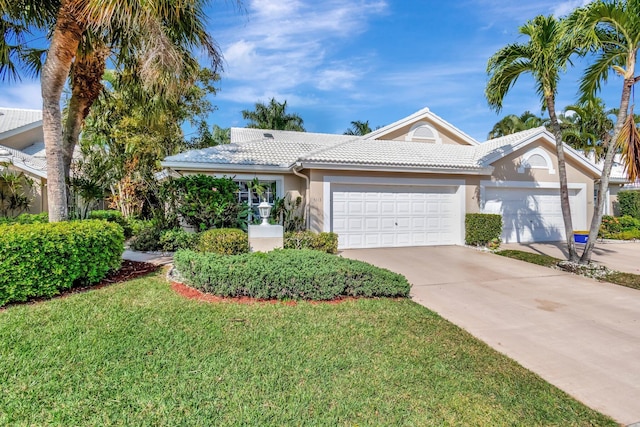 view of front of house with a garage and a front lawn