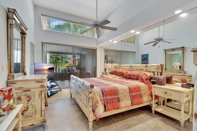 bedroom with light tile patterned floors, a towering ceiling, and ceiling fan