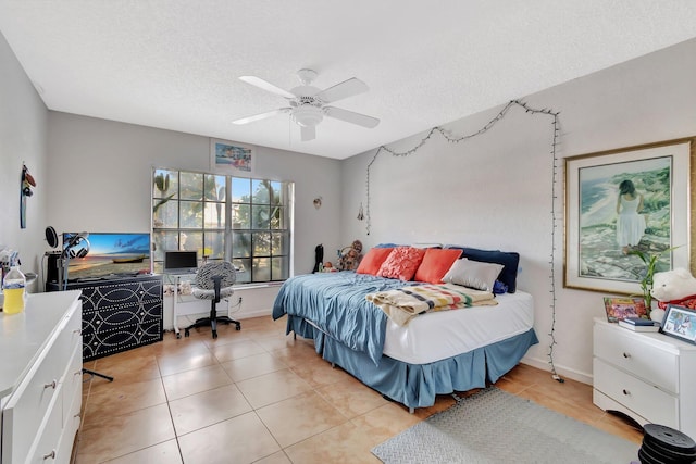 tiled bedroom featuring ceiling fan and a textured ceiling