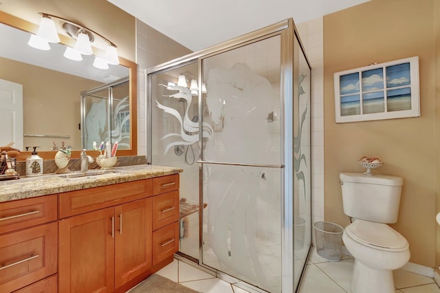 bathroom featuring tile patterned floors, vanity, toilet, and an enclosed shower