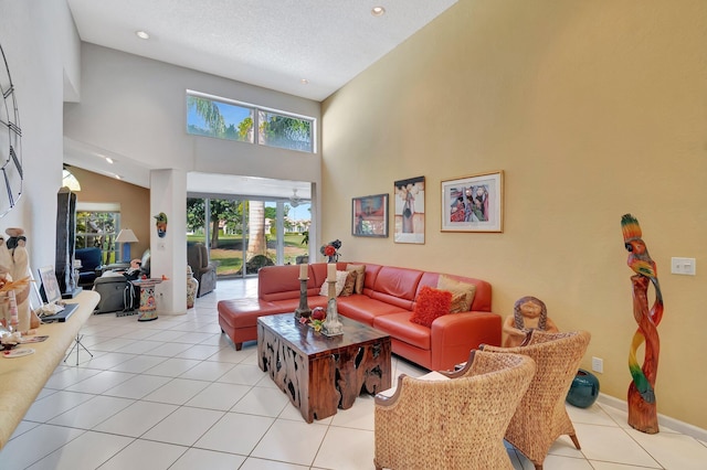 tiled living room with a textured ceiling and a high ceiling