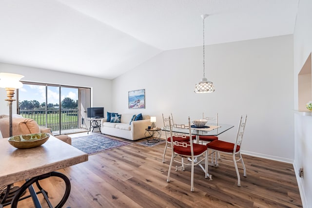 dining room featuring vaulted ceiling and wood-type flooring