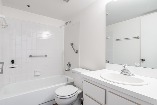 full bathroom with tiled shower / bath combo, vanity, and toilet