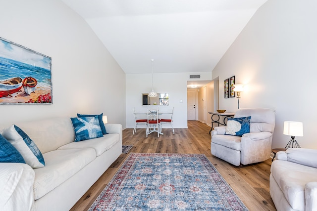 living room featuring vaulted ceiling and hardwood / wood-style floors