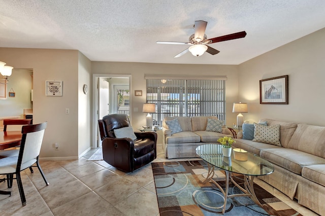 tiled living room with ceiling fan and a textured ceiling