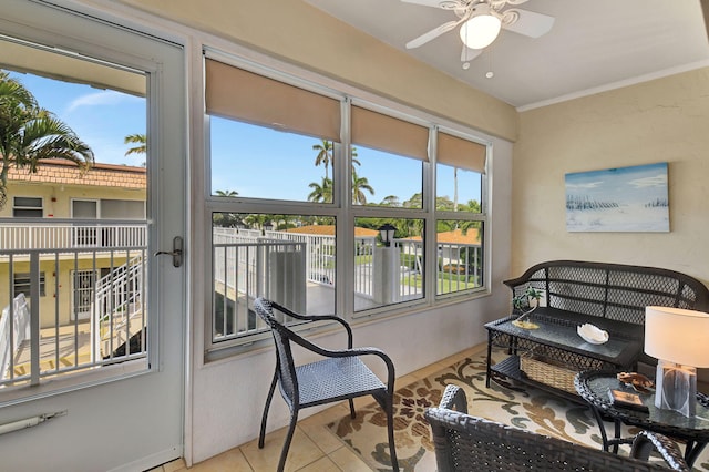 sunroom / solarium featuring a wealth of natural light and ceiling fan