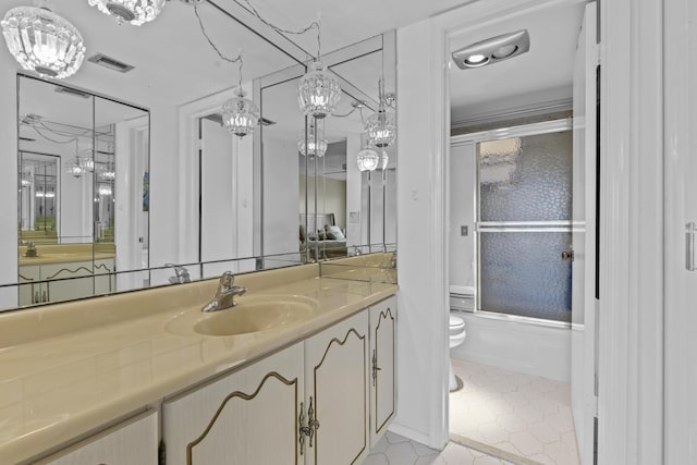 full bathroom with vanity, toilet, and combined bath / shower with glass door