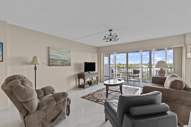 living room with a wealth of natural light, an inviting chandelier, and light tile patterned floors