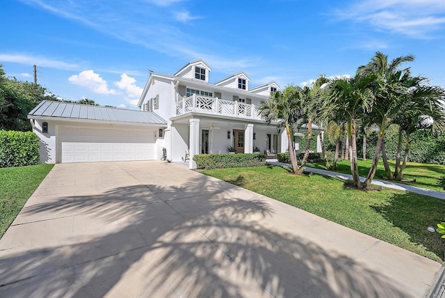 view of front facade featuring a balcony, a garage, covered porch, and a front lawn