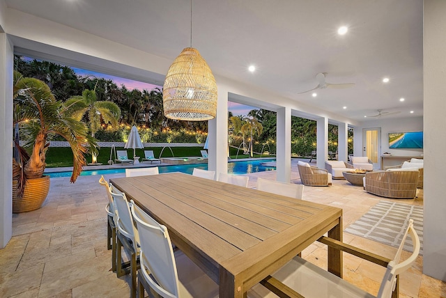 patio terrace at dusk with an outdoor living space, pool water feature, and ceiling fan