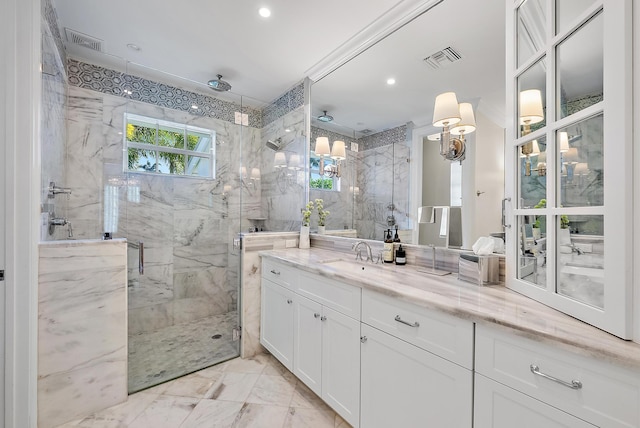 bathroom featuring an enclosed shower and vanity