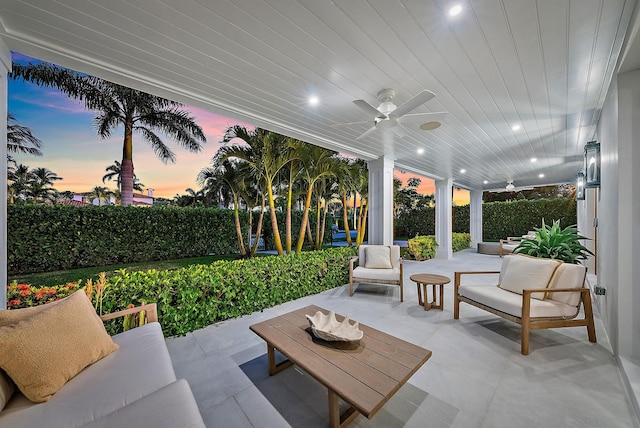 patio terrace at dusk featuring an outdoor hangout area and ceiling fan