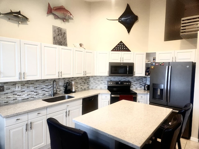 kitchen featuring a center island, sink, white cabinets, and black appliances