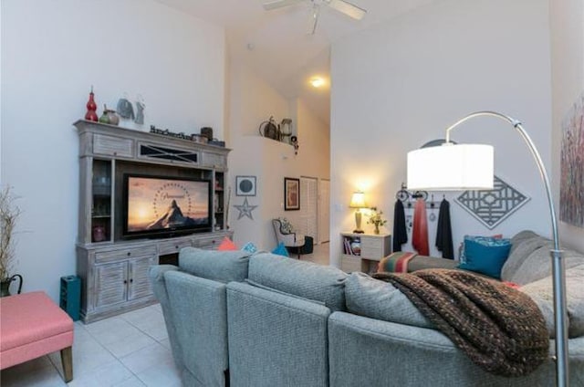 living room featuring ceiling fan, high vaulted ceiling, and light tile patterned floors