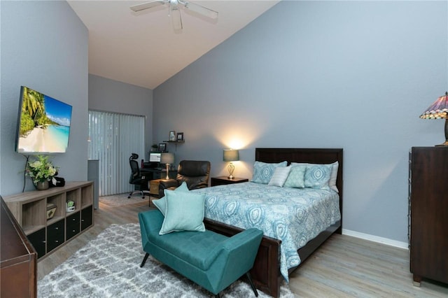 bedroom with ceiling fan, high vaulted ceiling, and hardwood / wood-style floors