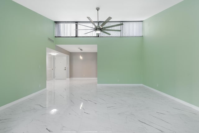 spare room with a high ceiling and ceiling fan