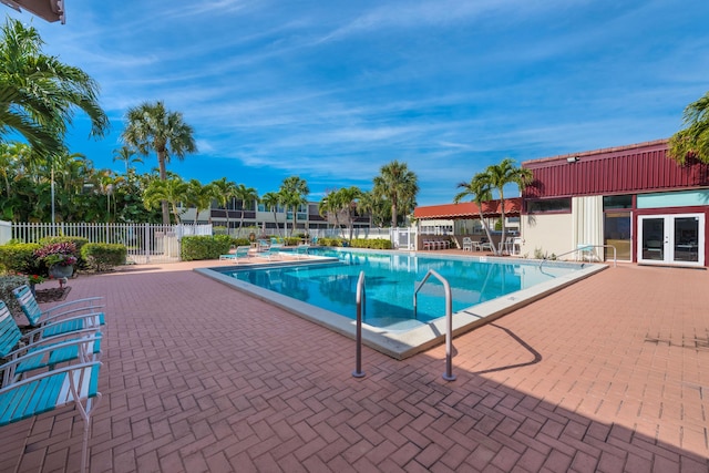 view of pool featuring french doors and a patio area