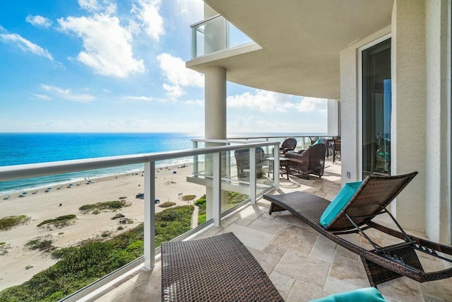 balcony with a view of the beach and a water view