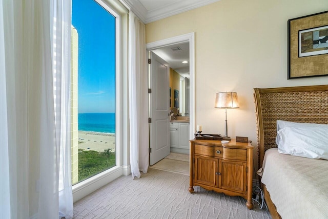 carpeted bedroom with ornamental molding and a water view