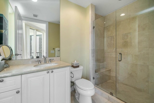 bathroom featuring walk in shower, vanity, and toilet