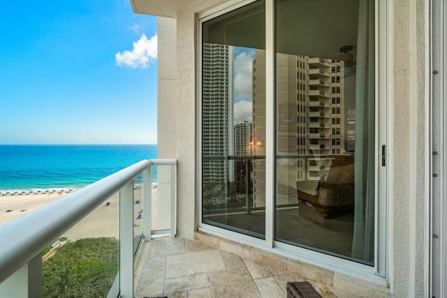 balcony featuring a water view and a view of the beach