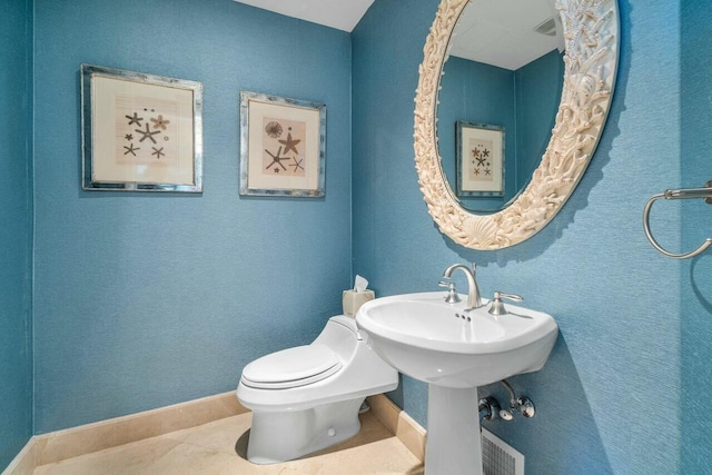 bathroom featuring tile patterned flooring and toilet