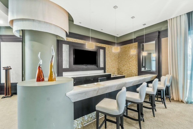 bar featuring pendant lighting and light colored carpet